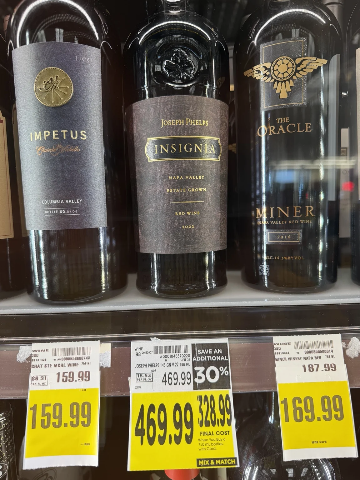 Daou, Silver Oak and J. Lohr Cabernet bottles displayed behind glass at Ralphs, with Silver Oak priced at $299.99.