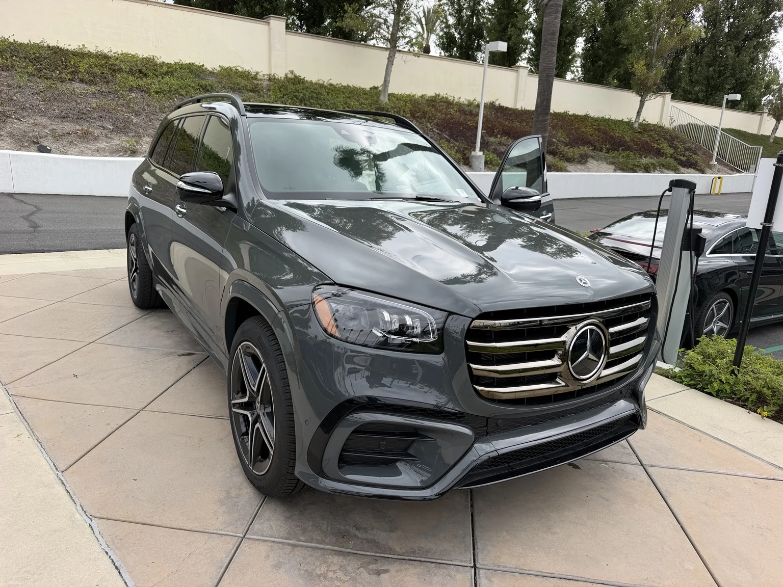 Front three-quarter view of a gray Mercedes-Benz GLS SUV parked outside the Foothill Ranch dealership.