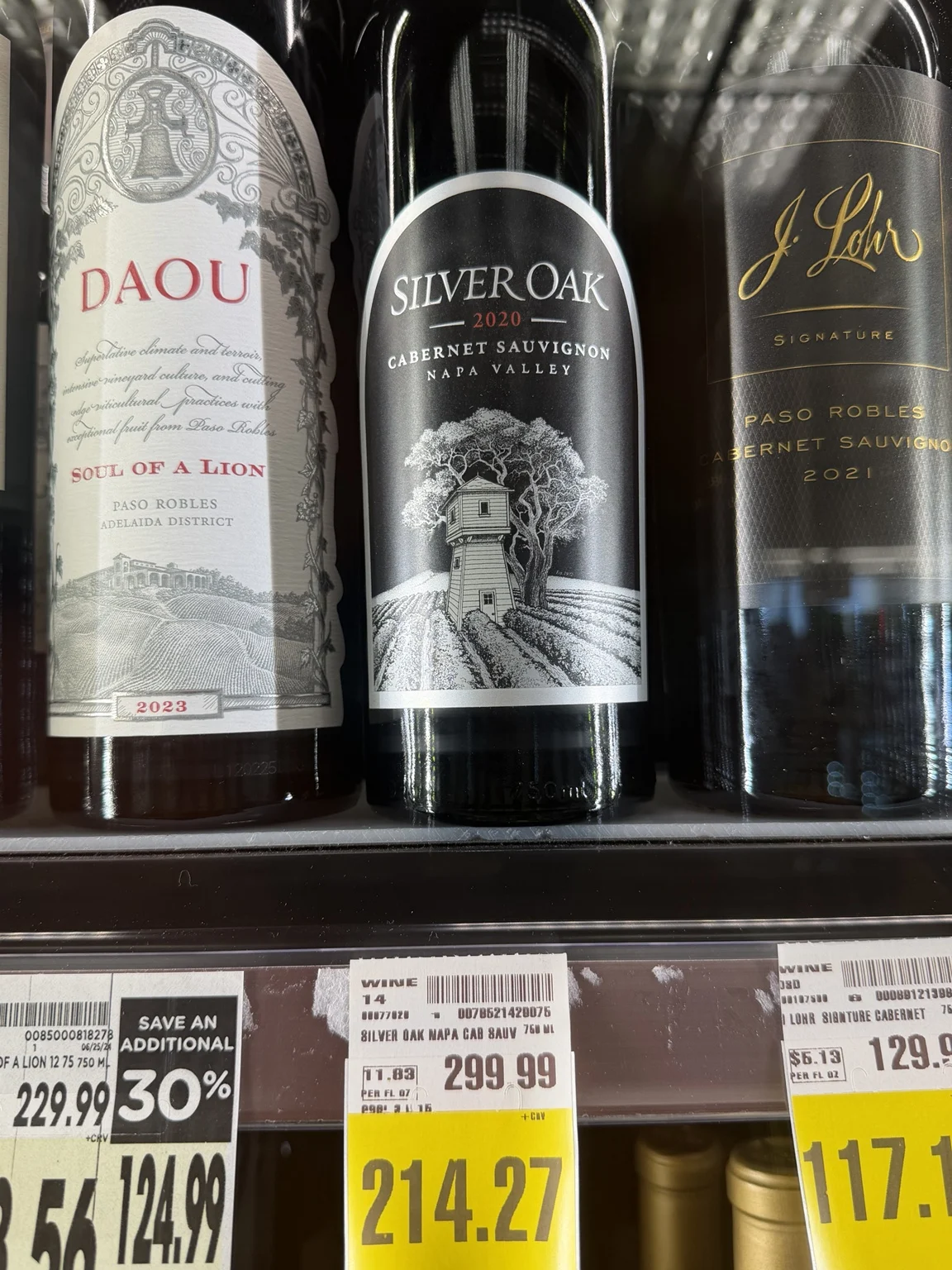 High-end red wines behind glass at Ralphs, including Impetus, Joseph Phelps Insignia and The Oracle.