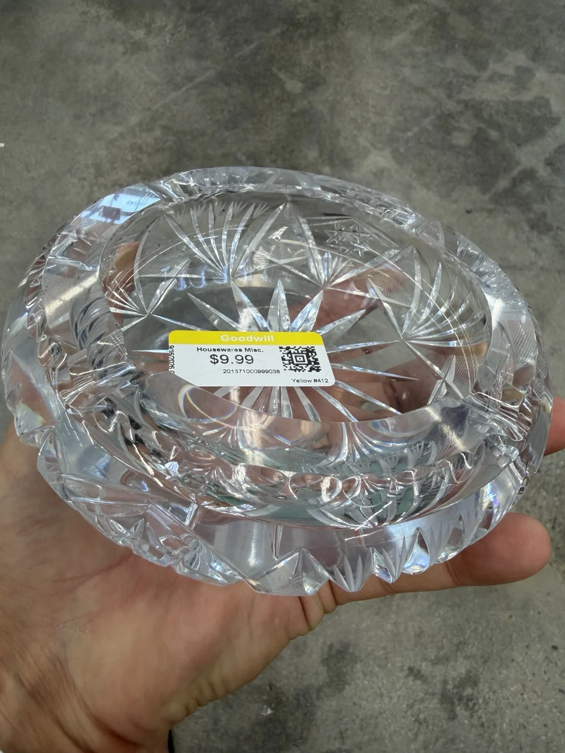 Close angled view showing the ashtray’s deep bowl, thick rim and substantial weight in the photographer’s hand.